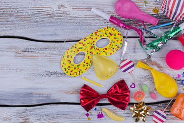 Birthday party balloons, blowers and decorations. Birthday accessories on wooden boards with copy space. Concept of childrens Birthday party.