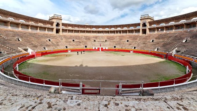 Time lapse motion cloudy sky and tourists visitors visited Palma de Mallorca arena bullring corrida ancient construction round shape where perform bullfighting running of bulls. Balearic Islands Spain
