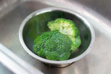 fresh broccoli wash in the sink 