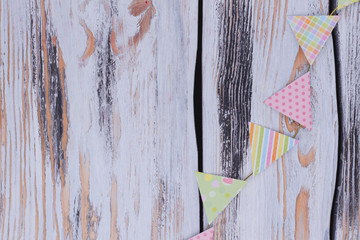 Birthday paper flags on rustic background. Decorative party flags on vintage wooden background with copy space.