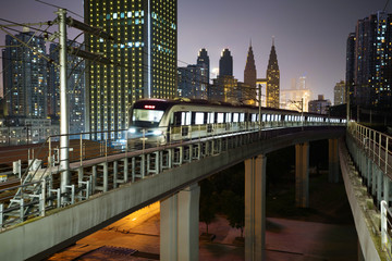 At night, the light rail train shuttles through the city.