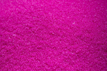 Close-up scene the  pile of pink raw plastic materials. The pellet of the thermoplastic material for injection process.