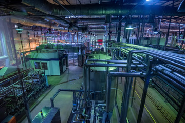 Industrial interior of soft drinks factory with tubes and reservoires