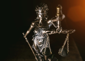 Statue of lady justice on bright background - Side view with copy space.