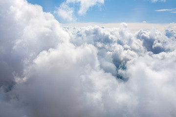 White clouds on blue sky background close up, cumulus clouds high in azure skies, beautiful aerial cloudscape view from above, sunny heaven landscape, bright cloudy sky view from airplane, copy space