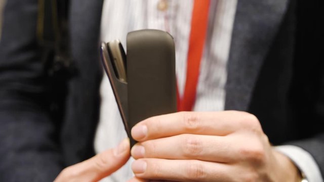 A man businessman in a white shirt opens a cigarette case closeup business