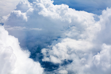 Fototapeta na wymiar White clouds on blue sky background close up, cumulus clouds high in azure skies, beautiful aerial cloudscape view from above, sunny heaven landscape, bright cloudy sky view from airplane, copy space