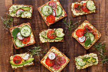 Sandwiches with cream cheese, vegetables and salami.