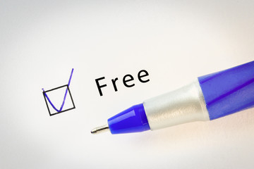 Free - checkbox with a tick on white paper with blue pen.
