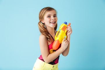 Cheerful little girl wearing swimsuit standing isolated