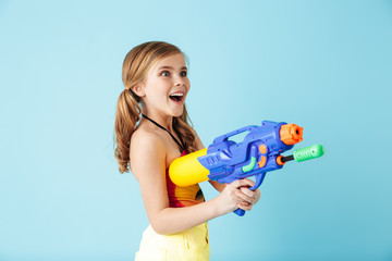 Cheerful little girl wearing swimsuit standing isolated