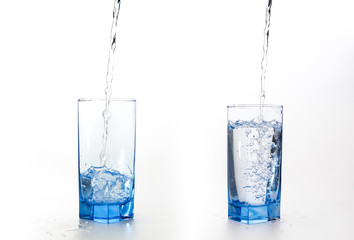pouring fresh drink water to blue glass