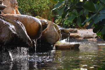 Rock waterfall with trees and a river