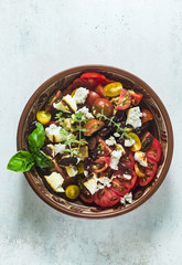 Italian traditional Tuscan panzanella salad with fresh tomatoes and cheese in clay plates. authentic Mediterranean healthy food