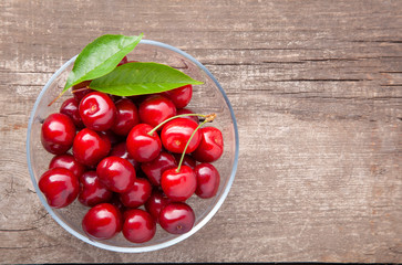 Ripe cherries on wooden table. Top View with copy space