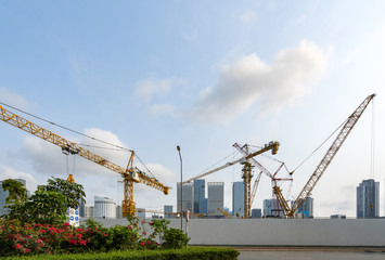 Fototapeta na wymiar Tower cranes, skyscrapers on construction sites
