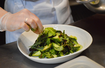 Cooking salad from avocado and leaf lettuce