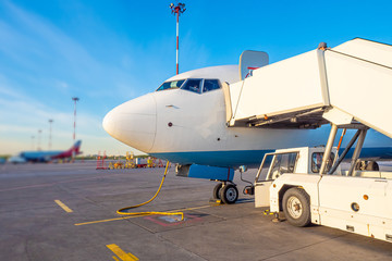 Airport. The operator docked the ladder to the plane for landing. Plane with a rolling ladder....