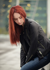 Portrait of attractive red haired young woman with blue eyes.