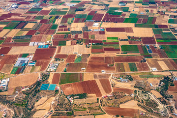 Cyprus. Countryside houses with cultivated fields view from height. Farmland. Agriculture in Cyprus. Farming. Agronomy. Harvest. Rural area of Cyprus.