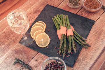 bunches of asparagus wrapped in salmon with spices and wine