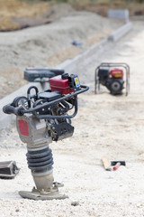 Vibrating plate machine at construction site