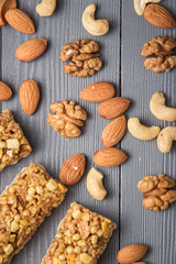 Granola cereal flakes with nuts on gray wooden table. Top view.
