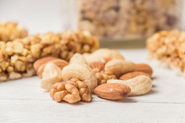 Assortment of nuts on white wooden table. Cashew, hazelnuts, walnuts, almonds.