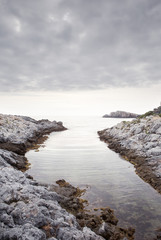 Fototapeta na wymiar stony beach against a calm sea