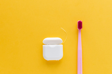Dental hygiene - tooth brush flat lay, top view, copy space, yellow background