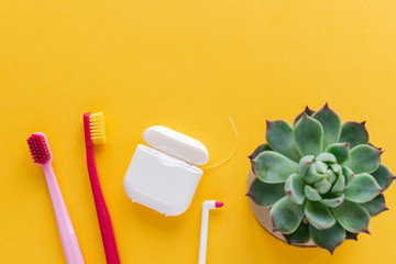 Dental hygiene - tooth brushes, dental floss, mouthwash flat lay, top view, copy space, yellow...
