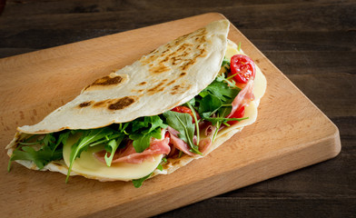 Romagna piadina filled on  chopping board