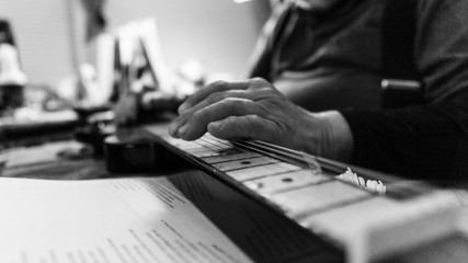 Arthritic hands playing the guitar weathered old hands playing music