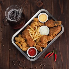 Chicken nuggets and french fries, sauces of ketchup and mayonnaise