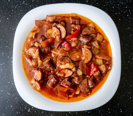 Ketogenic meal, fat Letcho with sausage, bacon, pepper and tomato