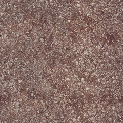 The soil under the feet is red and consists of small stones and sticks.Texture or background