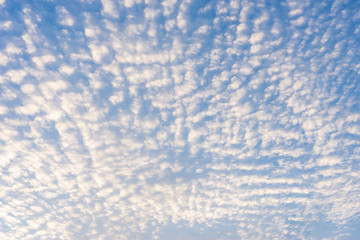 Blue sky with clouds in the morning sun rise .
