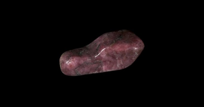Pink Rhodonite Mineral Turning on Black