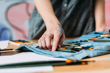 Creativity crisis. Cropped shot of artist standing over paintbrush organizer in workshop.