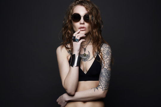 tattooed girl in underwear, sunglasses and jewelry