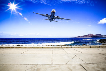 Fototapeta na wymiar Summer background of ocean with free space for your decoration on coast. Airplane on the sky and sunny day. 