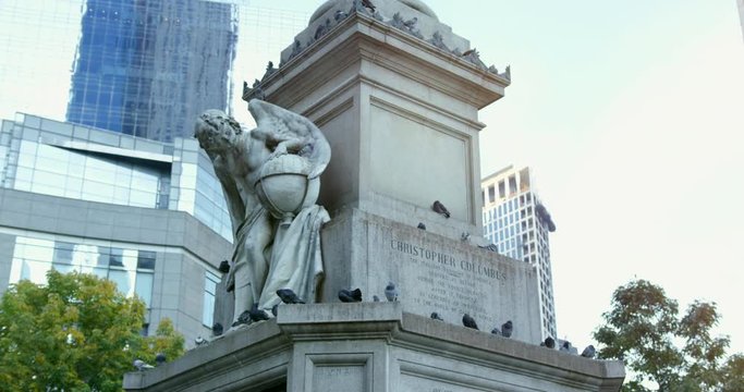 Christopher Columbus Monument In New York City, Manhattan. Famous Statue In NYC.  Pan Across,Birds Sat On The Statue. Important Person In America On A Beautiful Sunny Day.