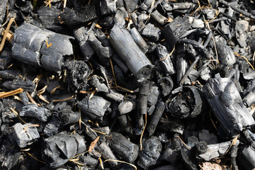 Natural coal with a dark gray texture. It is a flammable blak raw material.