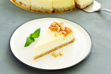 Cheesecake with caramel and peanuts. Slice.