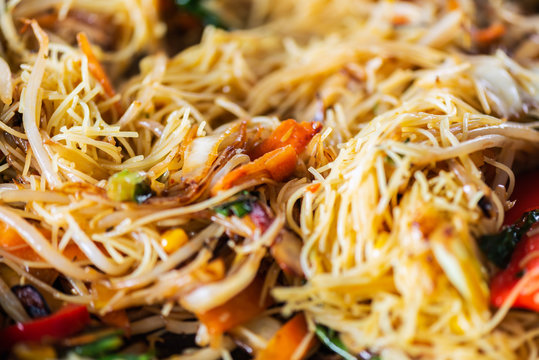 Process of cooking of sweet and crunchy stir fry with beansprouts and noodles in the wok, Macro image
