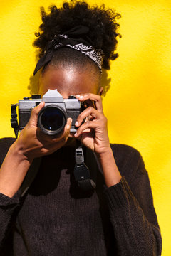 African girl looking into camera lens close up
