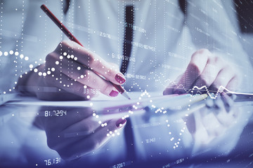 Double exposure of woman's writing hand on background with data technology hud. Big data concept.
