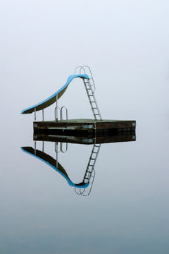 Serene Dock Slide in Morning Fog
