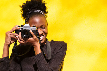 Portrait of african american girl taking photo