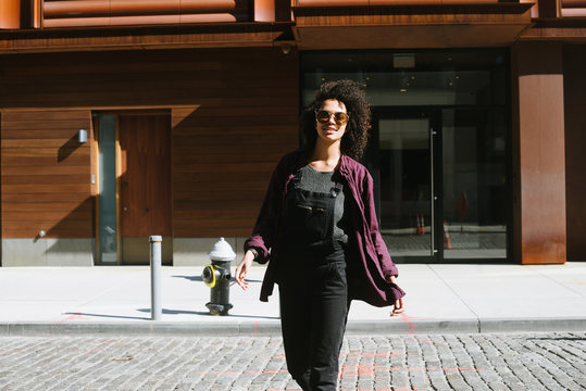 Portrait of young woman in front of building